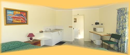 Wide angle view of kitchenette and access to bathroom.